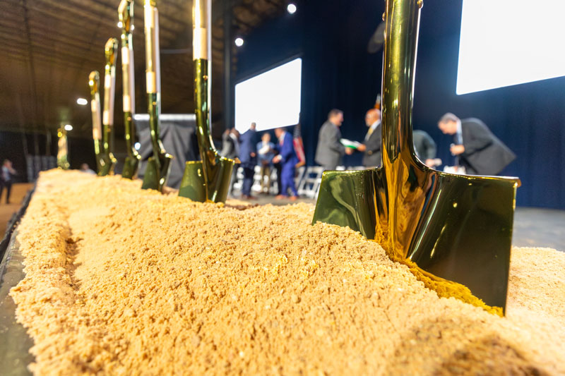 golden shovels in dirt.